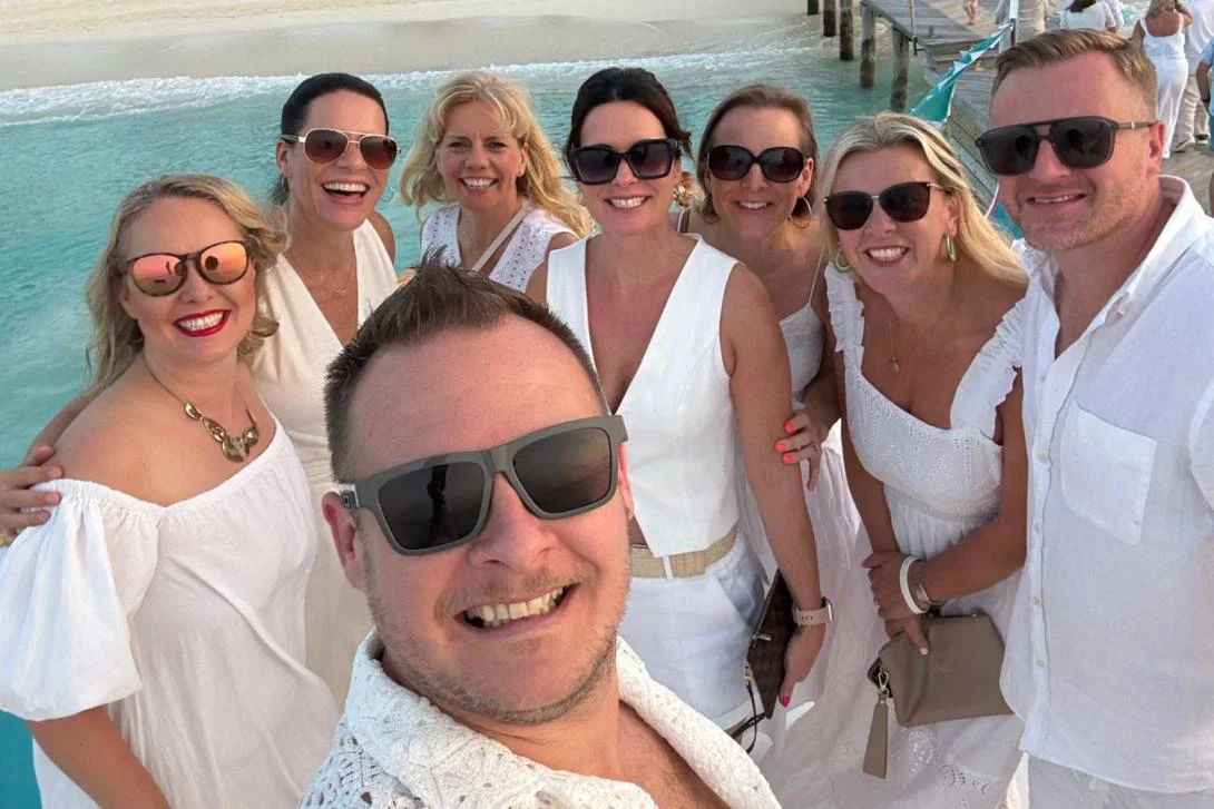 Selfie of group of white people smiling on sunny holiday