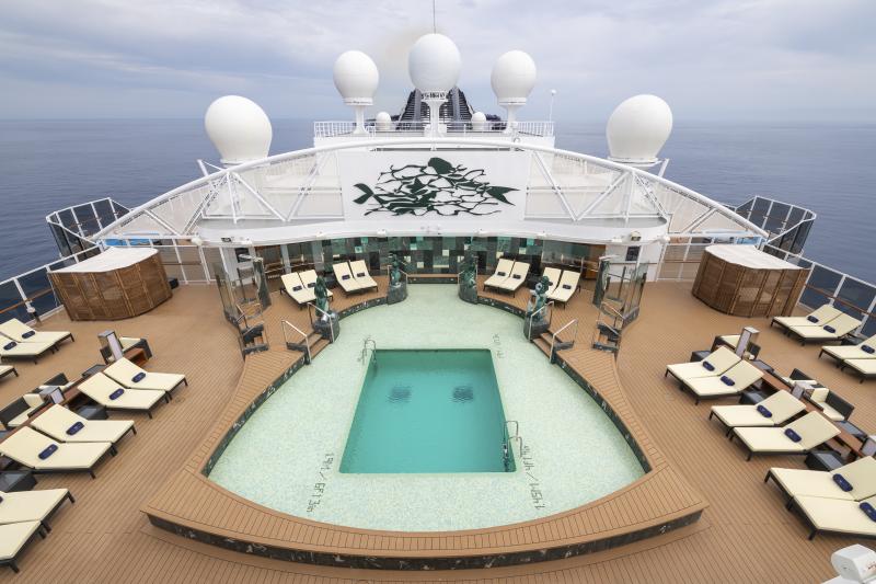 View of pool and sunbeds on MSC Yacht Club sundeck