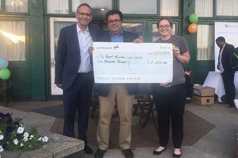 WHA’s Chris Photi and MacIntyre Hudson’s Rajeev Shaunak present a cheque to The Royal Marsden Cancer Charity