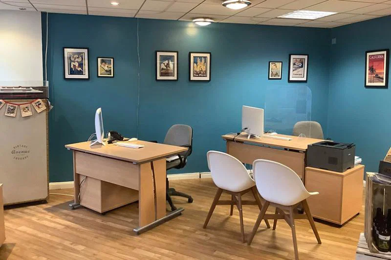 The Getaway Travel team painted the walls a teal shade and created art from an old calendar