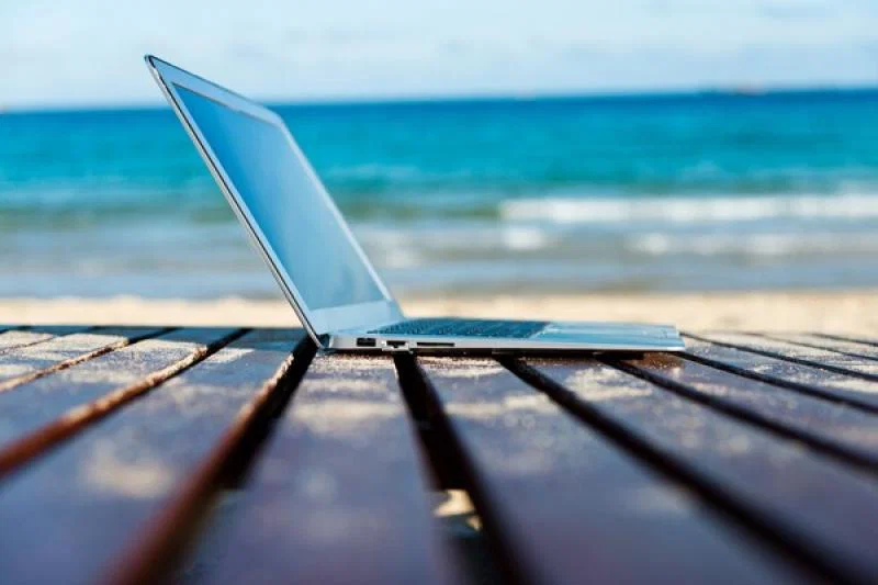 Laptop on beach working from home (Credit-baona).jpg