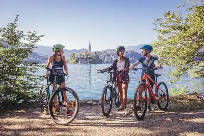 Clients can bike around Lake Bled in Slovenia with Intrepid Travel. The operator details carbon emissions on more than half of its trips