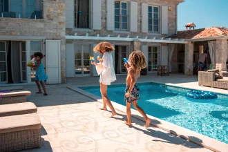 A family play together by a pool